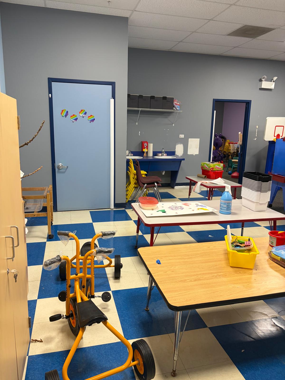 Activity classroom with tricycles and student tables